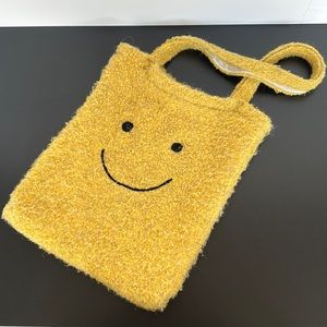 Yellow tote bag with a smile